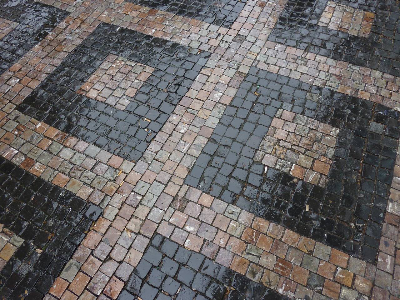 Professional paver driveway installation process with construction workers laying pavers in Palm Beach County